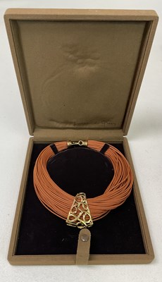 Lot 596 - LUISA DE GRESY; a fabric strand and gold...