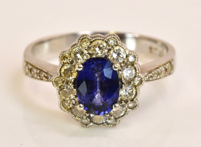 Lot 573 - An 18ct white gold sapphire and diamond oval...