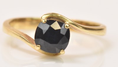 Lot 650 - A 9ct yellow gold dark sapphire single stone...