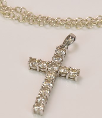 Lot 578 - An 18ct white gold diamond set cross pendant,...