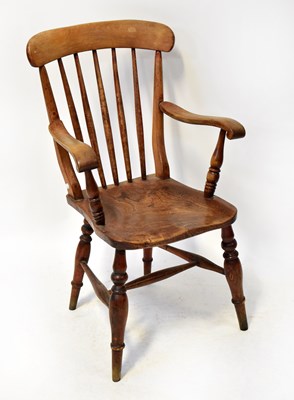 Lot 127 - A 19th century elm seated stick-back carver...