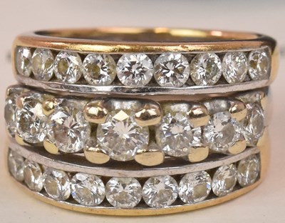 Lot 576 - An 18ct white gold and yellow gold three band...