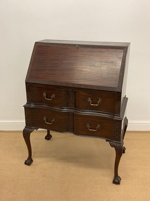 Lot 830 - An early 20th mahogany bureau with fret carved...