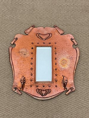 Lot 776 - A hammered copper Arts and Crafts wall mirror...