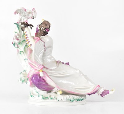 Lot 186 - MEISSEN; a figure reclining against a...