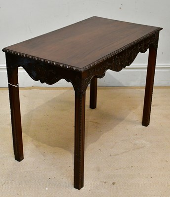 Lot 20 - A reproduction carved mahogany side table on...