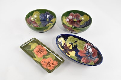 Lot 422 - MOORCROFT; four pieces comprising an oval bowl...