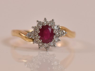 Lot 582 - An 18ct yellow gold diamond and ruby floral...