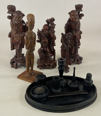 Lot 31 - Four Chinese carved wood immortals and another...