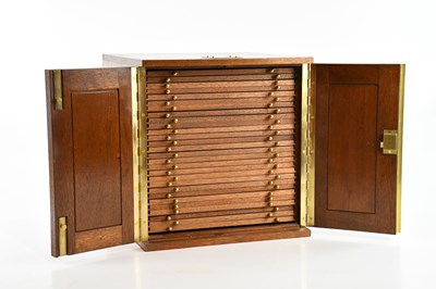 Lot 633 - A teak coin cabinet housing twenty-eight...