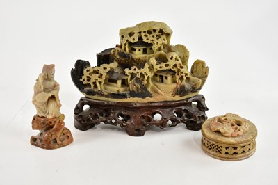 Lot 1116 - A Chinese carved soapstone model of figures...