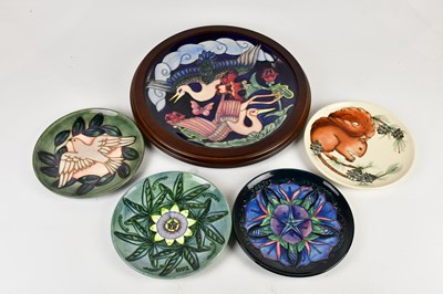 Lot 432 - MOORCROFT; a circular wall charger decorated...