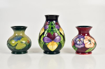 Lot 415 - MOORCROFT; three vases including an example...