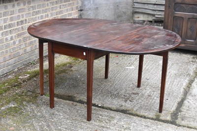 Lot 52 - A Georgian mahogany oval drop-leaf table on...