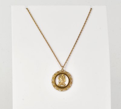 Lot 889 - A 9ct yellow gold pierced pendant depicting St...