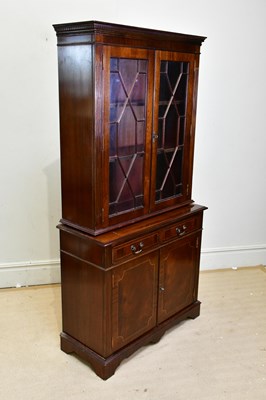 Lot 21 - A reproduction mahogany bookcase, the upper...