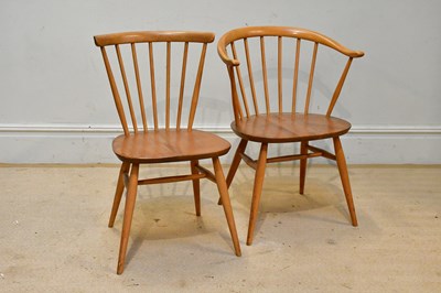 Lot 60 - ERCOL; an elm seated spindle back elbow chair...