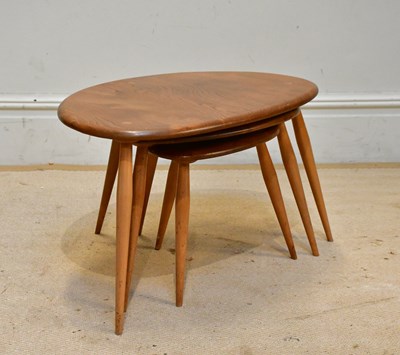 Lot 56 - ERCOL; a nest of three graduated Pebble coffee...