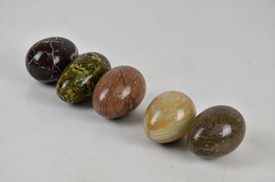 Lot 1216 - A collection of four polished rock eggs and a...