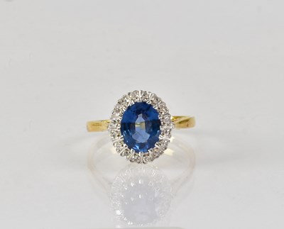 Lot 829 - An 18ct yellow gold diamond and sapphire ring,...