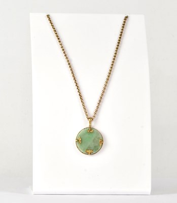 Lot 894 - A 9ct yellow gold mounted jade pendant, with...