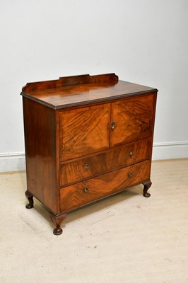 Lot 199 - A 1950s walnut tallboy, with two doors above...