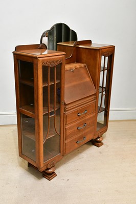 Lot 178 - A 1950s carved oak mirror back bureau cabinet,...