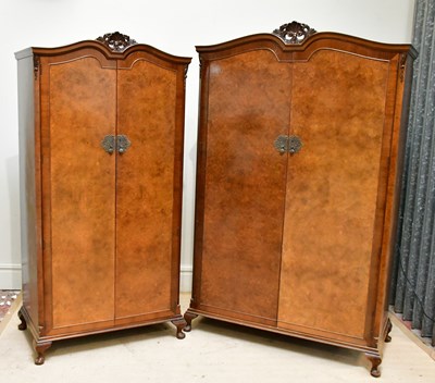 Lot 22 - Two walnut twin door wardrobes, with carved...