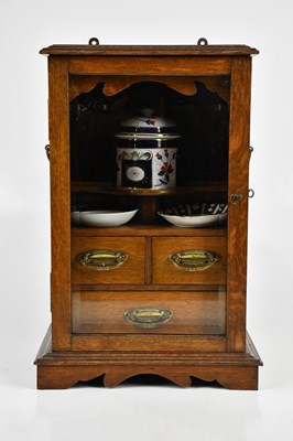 Lot 1254 - An early 20th century oak smoker's cabinet,...