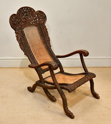 Lot 99 - An Anglo-Indian carved hardwood folding chair,...