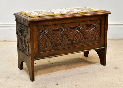 Lot 28 - A carved oak blanket chest with applied...