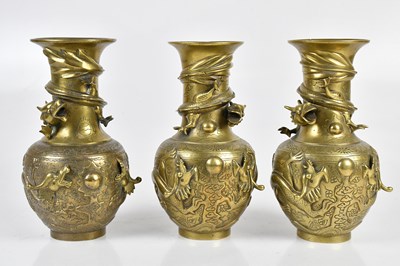 Lot 1101 - Three modern Chinese brass vases, relief...