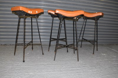 Lot 77 - A set of four tan leather seated wrought iron...