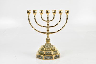 Lot 1358 - A Danish brass menorah, on stepped octagonal...