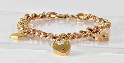 Lot 869 - A 15ct yellow gold curb link bracelet set with...