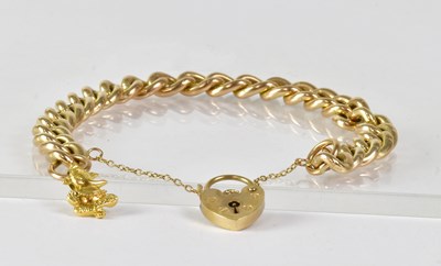 Lot 868 - A 9ct gold curb link bracelet set with a...