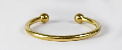 Lot 861 - A 9ct gold torque bangle, stamped '375',...