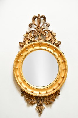 Lot 81 - A Regency style gilt framed convex wall mirror...