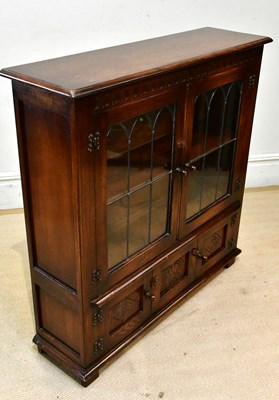 Lot 24 - A reproduction oak bookcase, the pair of lead...