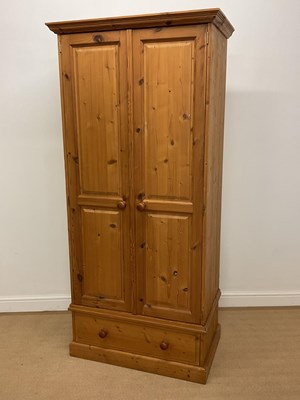 Lot 842 - A pine wardrobe with a single drawer to the...