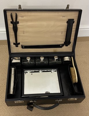 Lot 19 - A black morroco travel case with fitted...