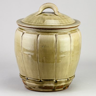 Lot 504 - MIKE DODD (born 1943); a faceted stoneware jar...