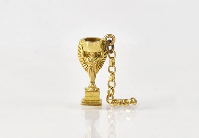 Lot 932 - A 9ct yellow gold Jules Rimet World Cup charm,...