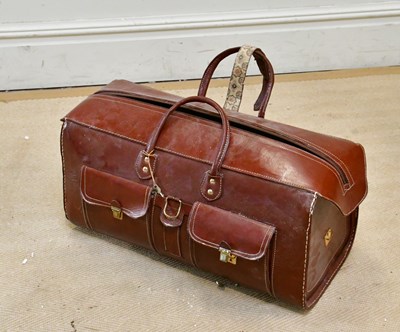 Lot 1269 - A large tan leather holdall, with two pockets,...