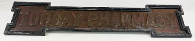 Lot 3 - TORBAY PHARMACY; a hammered copper shop front...