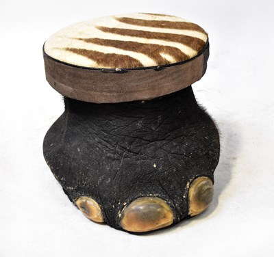 Lot 374 - An elephant foot stool with zebra skin covered...