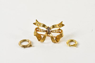 Lot 1247 - A yellow metal and diamond set bow brooch,...