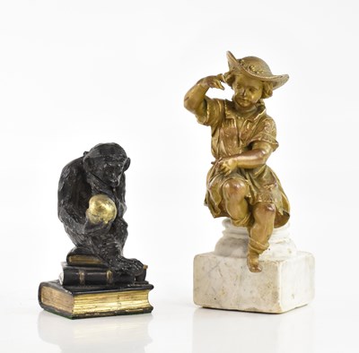 Lot 1397 - A bronzed spelter figure representing a seated...