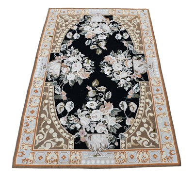 Lot 302 - A brown ground Aubusson style rug with central...