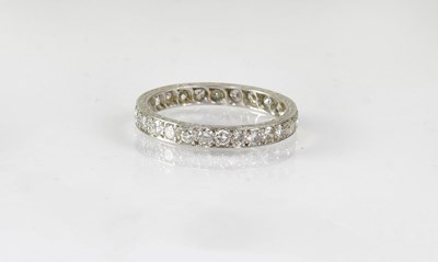 Lot 851 - A white metal and diamond eternity ring, size...